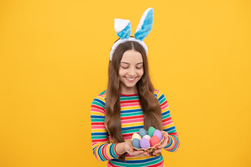 happy easter kid girl in rabbit bunny ears hold colorful eggs for holiday, easter bunny