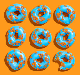 Colorful Blue donuts on orange background