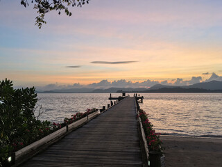 Obraz premium The bridge juts into the sea at sunset