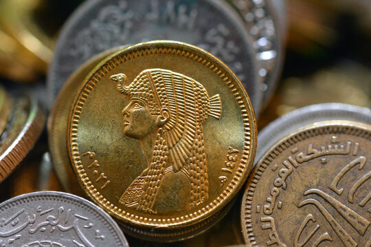 The obverse side of Egyptian 50 fifty piasters 2021 AD, 1442 AH, on a blurred multiple coins background, circulating Egyptian coins money background with queen Cleopatra slogan