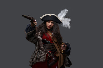 Pirate woman dressed in medieval clothing with gun