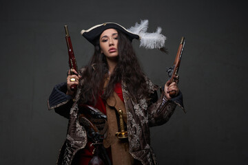 Woman corsair with long wavy hairs and guns