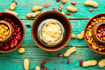 Homemade peanut butter on retro wooden table