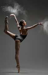 Artistic ballerina wearing black activewar and dancing © Fxquadro