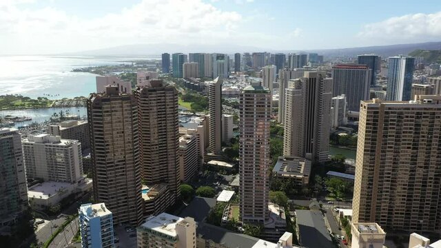 Cinematic 4K aerial drone rise and reveal shot of hotels, condominiums, apartments, offices between Waikiki and Honolulu on Oahu island, Hawaii