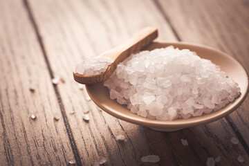 Rock white salt in bowl on wooden background