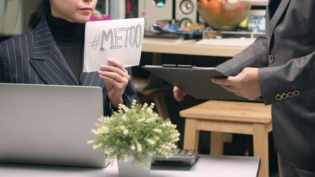 A Woman In The Workplace Gestures For A Coworker To Respect Her Personal Space - Concept: Sexual Harassment, Me Too Hashtag