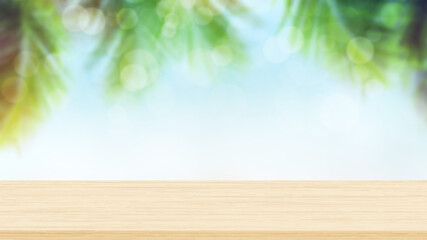 Empty wood table top with sunny tropical beach and palm trees background. Summer background concept