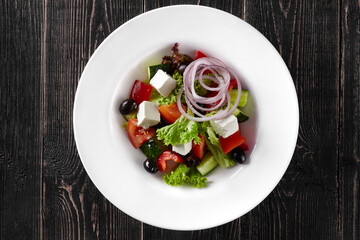 Greek salad with fresh vegetables, feta cheese and black olives