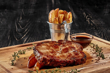 Pork steak with country style potatoes and barbecue sauce