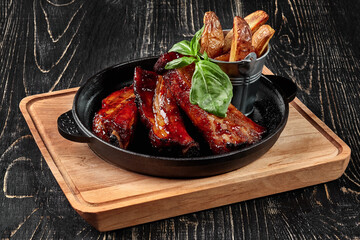 Grilled pork ribs with barbecue sauce and potato wedges