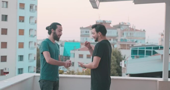 Young friends are rock paper scissors on holiday time. Cheerful friendship and game concept.