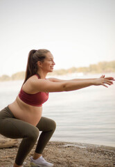Fototapeta na wymiar Pregnant woman working yoga on the beach.