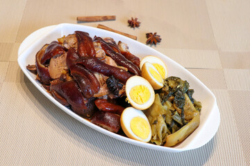 Top view of Pa lo or Belly pork stew chinese style with boiled eggs served with pickled lettuces very famous in Thailand street food as well.