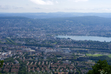 Obraz premium Panoramic view over City of Zurich with lake Zurich seen from local mountain Uetliberg on a summer day morning. Photo taken June 29th, 2021, Zurich, Switzerland.