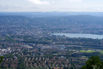 Panoramic view over City of Zurich with lake Zurich seen from local mountain Uetliberg on a summer day morning. Photo taken June 29th, 2021, Zurich, Switzerland.