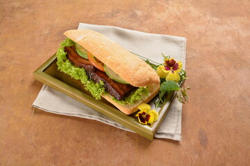 cook kong bak bao asian braised pork belly with vegetables in long focaccia bread and flower salad on wood table asian traditional pastry sandwich menu