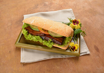 cook kong bak bao asian braised pork belly with vegetables in long focaccia bread and flower salad on wood table asian traditional pastry sandwich menu