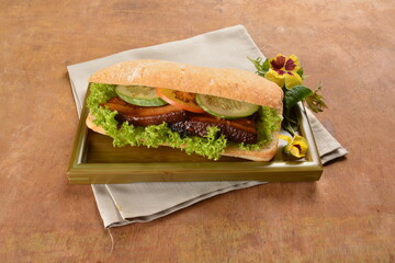 cook kong bak bao asian braised pork belly with vegetables in long focaccia bread and flower salad on wood table asian traditional pastry sandwich menu