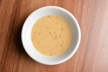 chef hand made cook salted egg yolk paste sauce in traditional cock chicken bowl on wood table asian halal menu