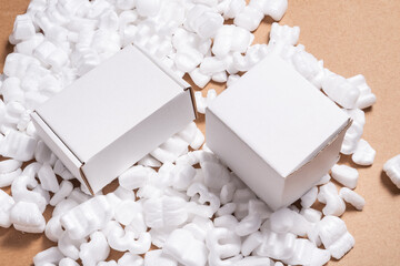 Cardboard box on loose white Filler Shipping Packing Peanuts