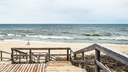 A wooden staircase descending to the sea