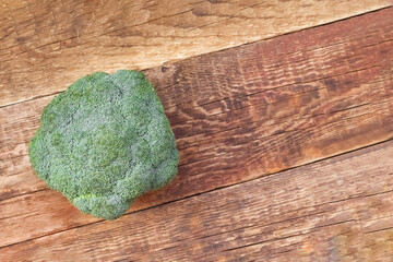 An empty space for the text. Broccoli on a brown board table.