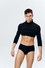 Fototapeta na wymiar sporty man with pumped up torso in shorts and black sweater cropped view