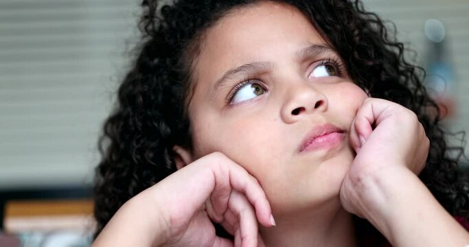 Child thinking about solution, pensive kid thoughtful girl