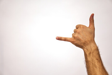 hang loose. Gesturing thumb and little finger. Hand of a Caucasian man on a white background. Place...