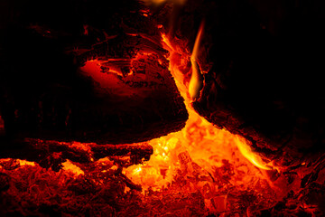 Embers and fire in the stove close-up. Abstract background. Image for the project, design.