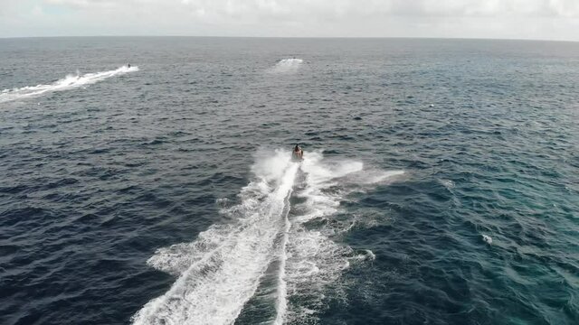Aerial view of a hydrocycle in a deep blue colored sea