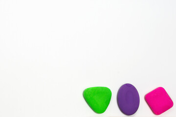 Colored school erasers on a white background. School supplies and stationery on white background.