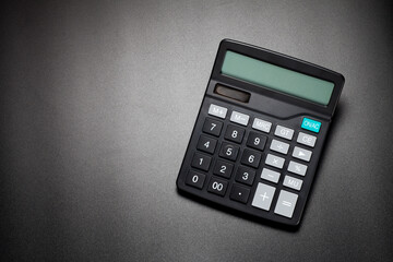 black calculator on black background. top view. - obrazy, fototapety, plakaty
