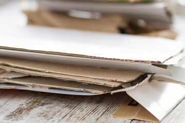 Cardboard scraps from a home stacked to be recycled