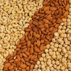 Close-up of nuts background: cashews, hazelnuts, almonds. Healthly food. A source of vitamins, microelements.