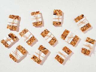 Granola bar and ingredients on a white stone table.Top view. Copy space.