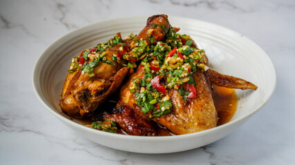 Thai Oyster chicken grilled with spicy sauce, cilantro, lime juice, red and green chillis.