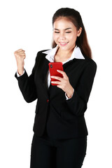 Smiling Asian woman wearing black suit holding hand smartphone to woring and socialmedia showing signs of joy and happiness in white background. Concept happy cheerful and delighted.