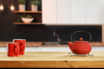 Wooden desk of free space and kettle with tea 