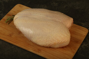Raw whole chicken breast with skin