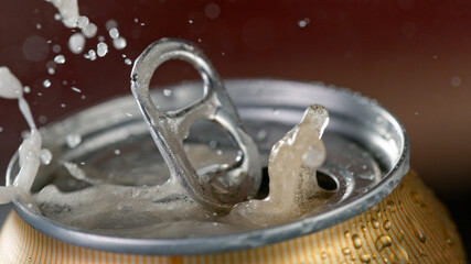 Freeze motiion of opening a can of beer. Macro shot.