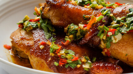 Thai Oyster chicken grilled with spicy sauce, cilantro, lime juice, red and green chillis.