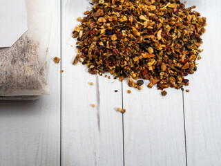 Fruit tea bags, one open and empty tea bag.