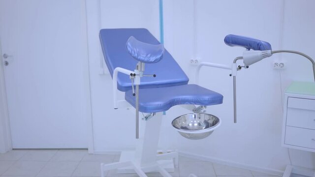 Blue gynecological chair in the women's health clinic. Close-up of an examination chair for pregnant women. The gynecologist's office is slow moving. Doctor's examination of pregnant women