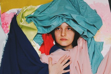 Funny comedy artistic abstract portrait ofyoung woman giving a serious pose in crazy background 