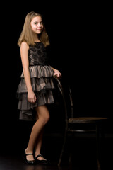 Obraz na płótnie Canvas Beautiful young teen girl studio photo on black background