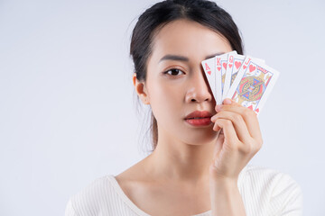 Young Asian woman holding poker card on hand