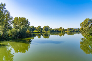 Fototapeta na wymiar Beautiful panorama of the lake landscape on a summer day in the Fuldaaue in Kassel, Germany