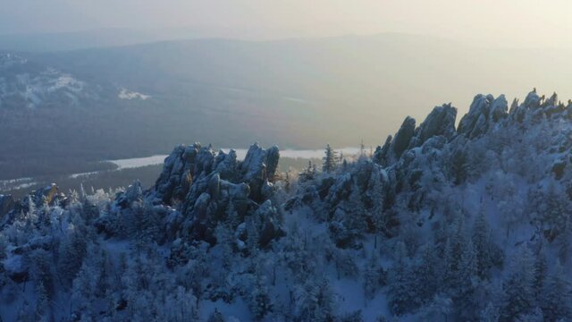 Snow-capped mountain ranges covered with coniferous forest. Taganay National Park in Russia. Aerial view